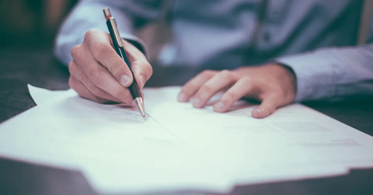 Person signing a contract document